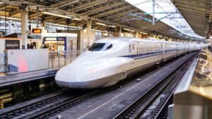 A white train stopped on a platform