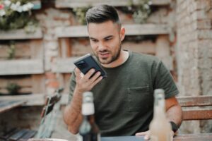 A man uses a voice assistant on his smartphone