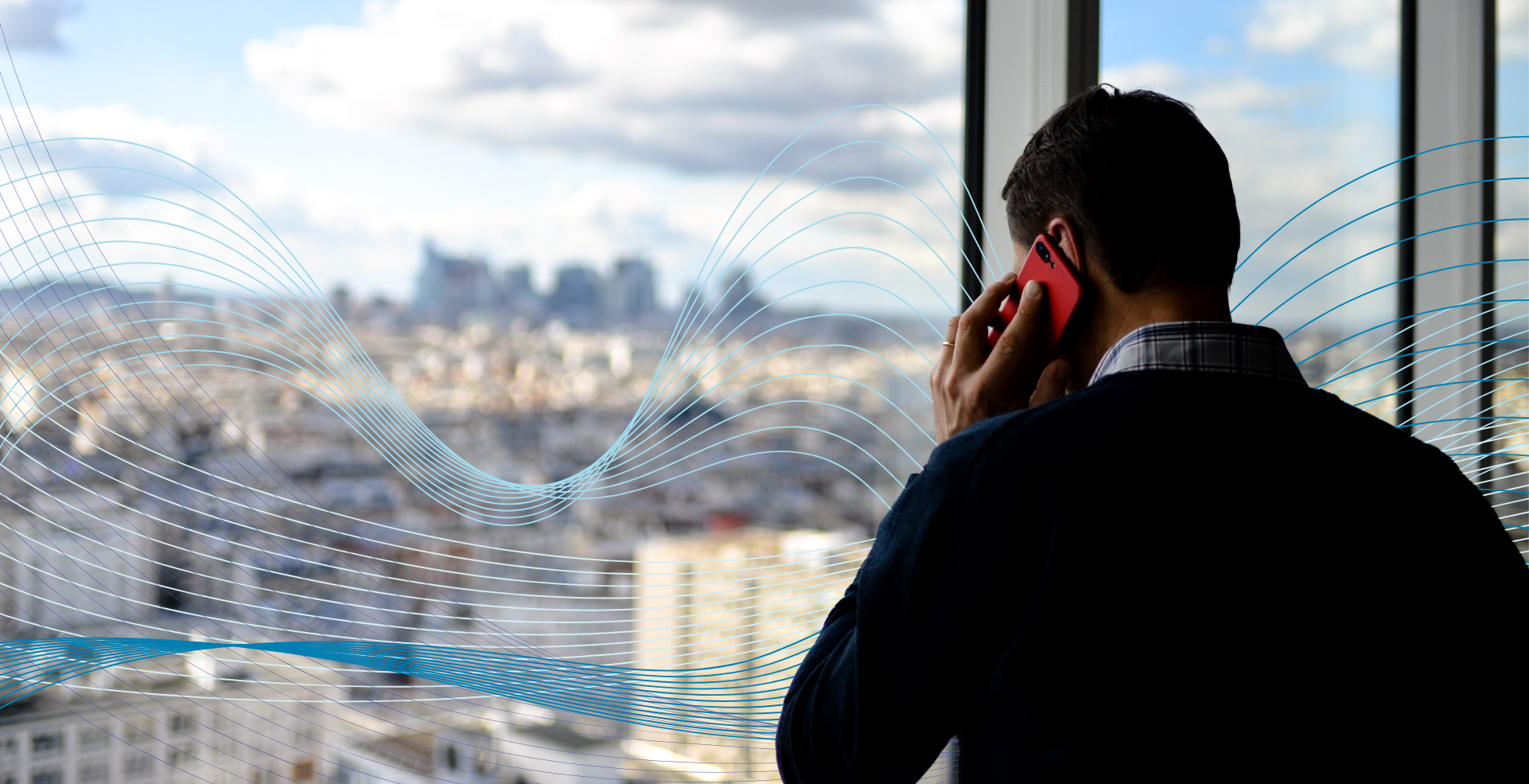 A man on the phone looks out the window