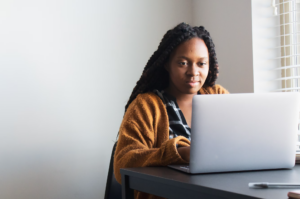 A black woman on a laptop